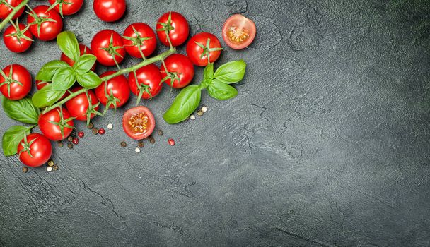 cherry tomatoes, basil and peppercorns on a dark concrete countertop - Φωτογραφία, εικόνα