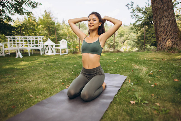 full-length retrato bela jovem ajuste menina praticando ioga ao ar livre - Foto, Imagem