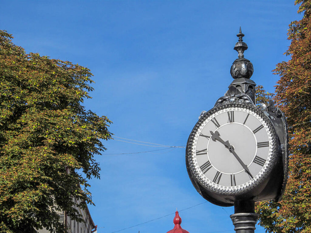 The dial of a street clock in the park. Ternopil, Ukraine - Zdjęcie, obraz
