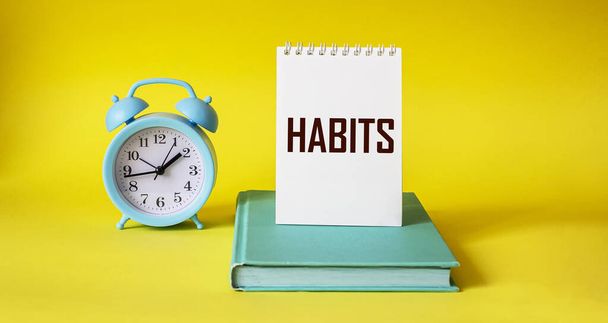 Habits word written on notepad and yellow background - Photo, Image