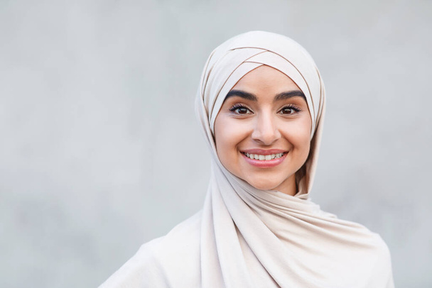 Портрет веселого милого привабливого молодого арабського ісламського жінки в хіджабі дивиться на камеру
 - Фото, зображення