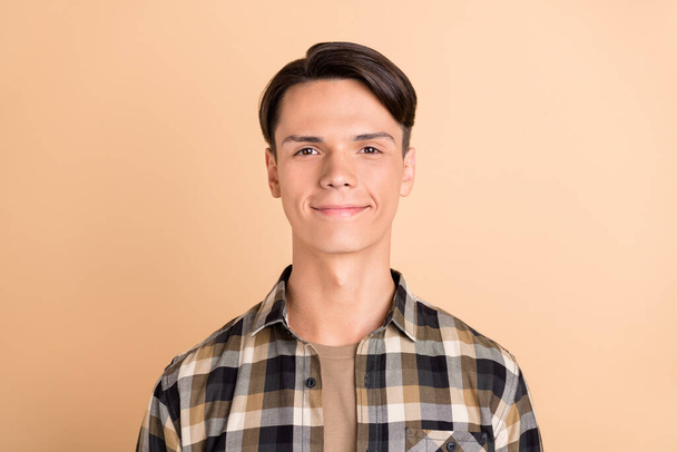 Photo of millennial cute guy wear checkered shirt isolated on beige color background - Fotografie, Obrázek