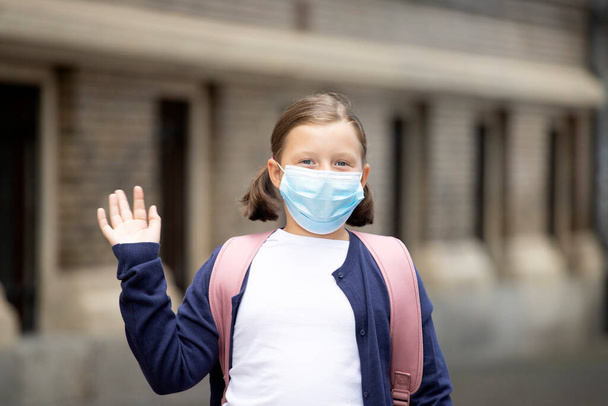Child with face mask going back to school after covid-19 quarantine and lockdown. - Valokuva, kuva