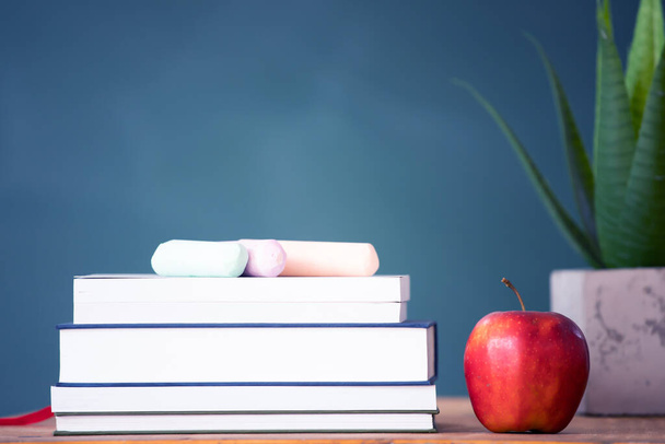 Back to school background with books and apple over blackboard - Φωτογραφία, εικόνα