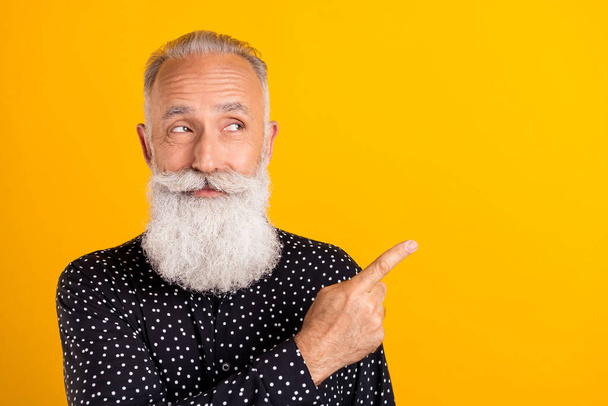 Photo portrait bearded man wearing shirt smiling showing finger copyspace isolated bright yellow color background - Foto, imagen