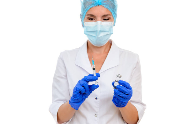 Nurse or doctor preparing a dose of covid-19 vaccine for vaccination, coronavirus vaccination concept. White isolated background - Foto, afbeelding