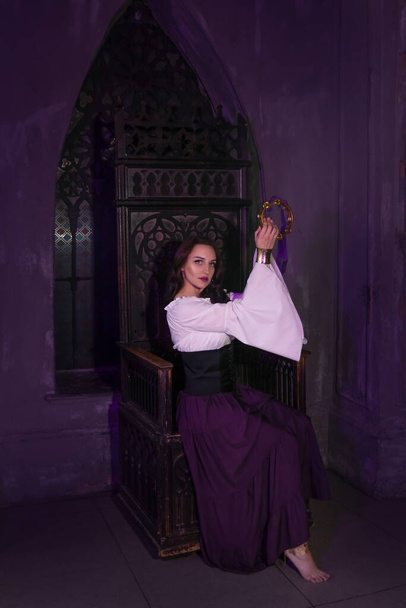 Beautiful gypsy woman closeup in the dark room of cathedral church. - Fotó, kép