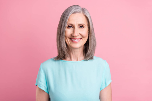 Photo of cute elder grey hairdo lady wear blue blouse isolated on pink color background - Foto, imagen