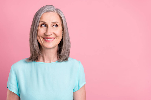 Photo of funny old grey hairdo lady look empty space wear blue blouse isolated on pink color background - Foto, afbeelding