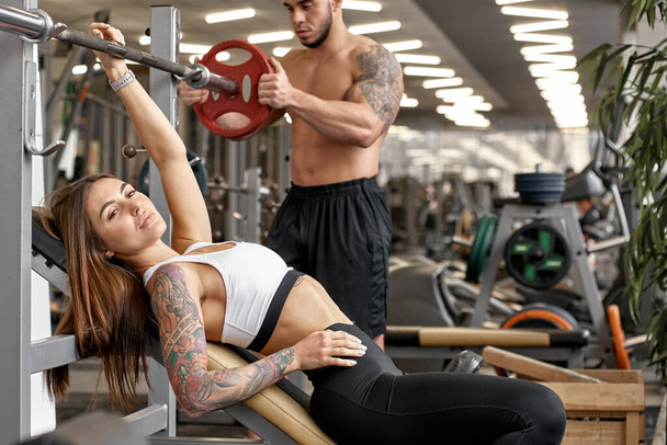 Weightlifting with personal trainer - Фото, зображення