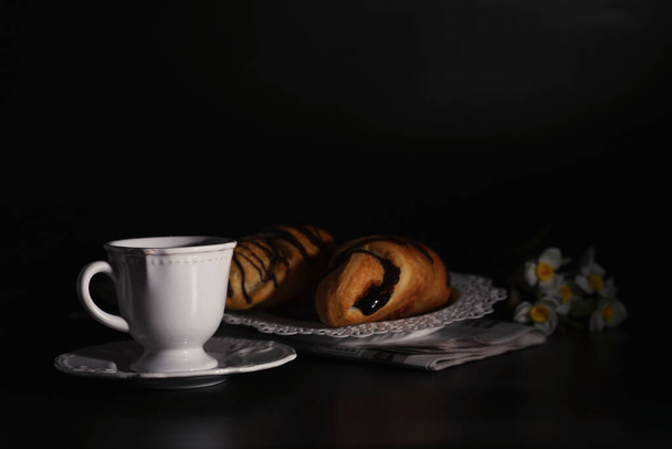 French breakfast on the table. Coffee croissant with chocolate and decanter with cream. Fresh pastries and decaffeinated coffee. - Photo, Image