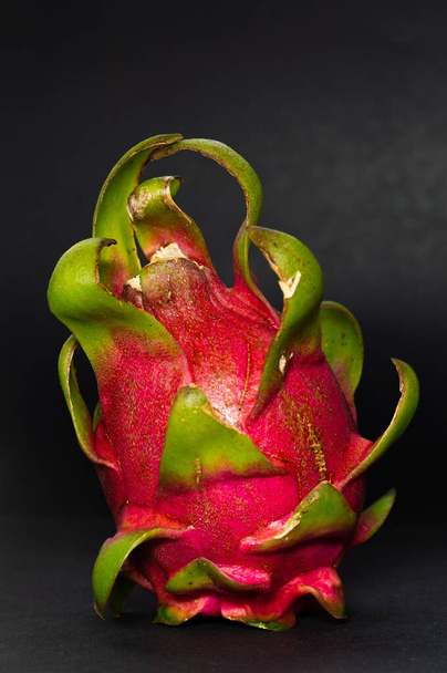 A closeup shot of a Dragon fruit or pitaya isolated on gray background in the studio - Foto, Bild