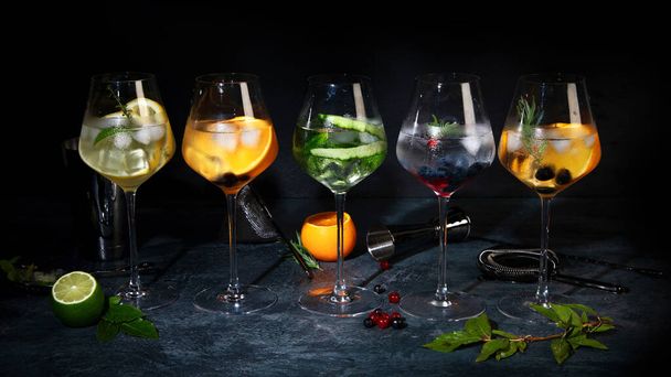 Gin cocktails assortment served on dark background. Creative drinks menu concept. Front view - 写真・画像