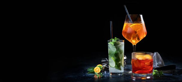 Cocktails assortment served on dark background. Classic drink menu concept. Copy space, panorama - 写真・画像