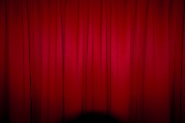 Red closed curtain with a light spot use for background - Photo, Image