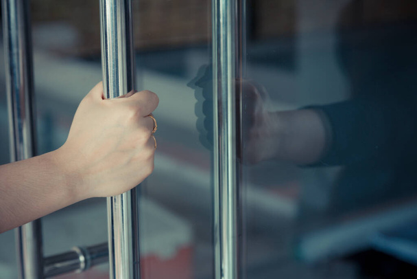 Woman's hand open the door with glass reflection background - Zdjęcie, obraz