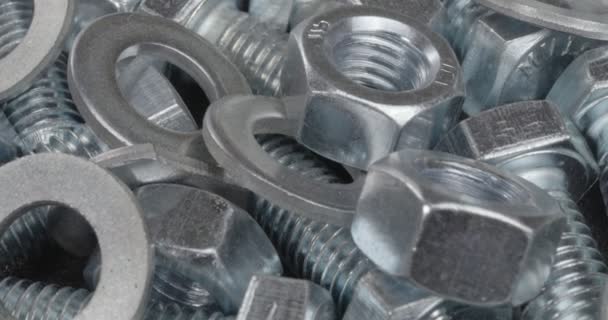 A group of bolts, nuts and washers close up. Fasteners. - Footage, Video