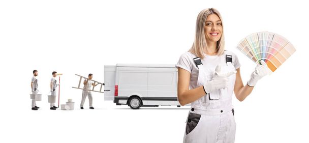 Female painter holding a color palette and workers with a white van isolated on white background - Photo, image
