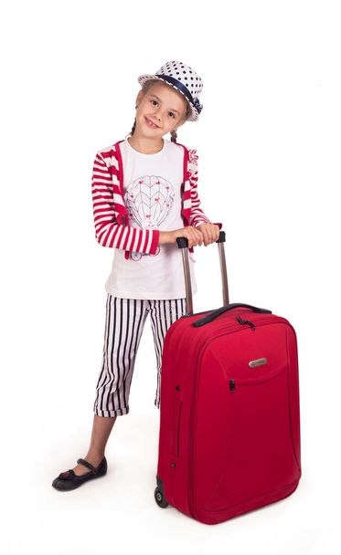 Portrait of little girl with travel case and hat isolated on white - Zdjęcie, obraz