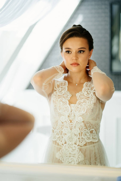 a beautiful young woman in a lace robe by the mirror  - Fotoğraf, Görsel