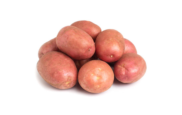 Heap of potatoes with red peel on a white background, isolate. Close-up, carbohydrate - Foto, Imagem