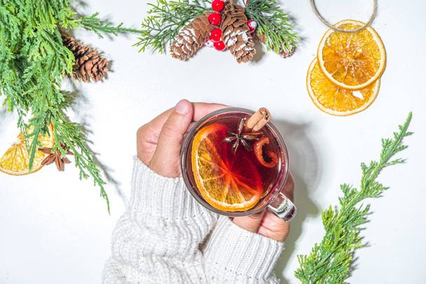 Mulled wine, traditional hot winter autumn alcohol boozy drink, with cinnamon, anise and orange, On Christmas decorated background copy space - Foto, immagini