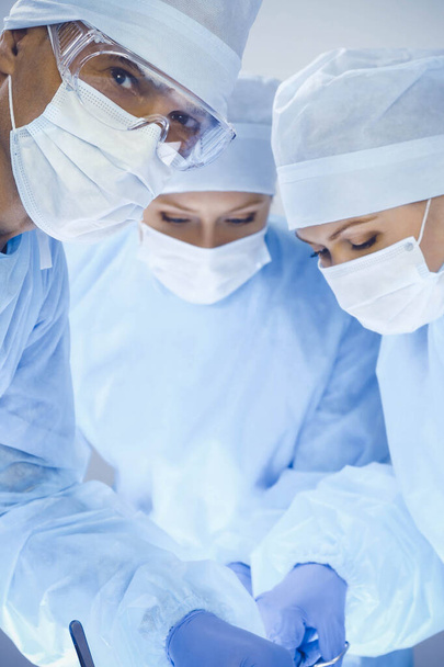 A group of surgeons is operating at the hospital. Health care concept - Valokuva, kuva