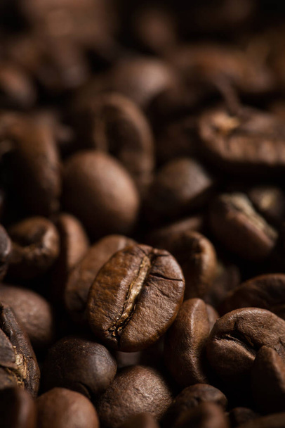 Coffee beans close-up. Macro photography of coffee on a brown background. A place for text in food photos. Arabica. - Photo, Image