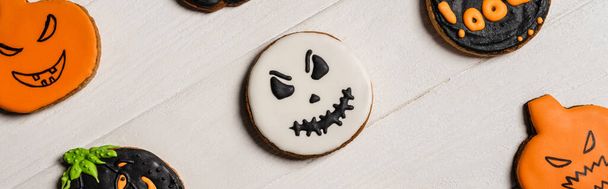 top view of sweet and spooky halloween cookies on white surface, banner - Fotó, kép