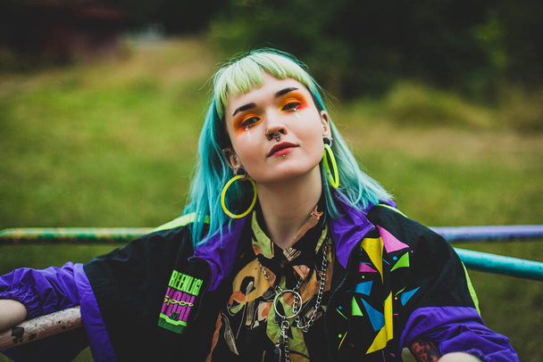 Back in time 90s 80s. Stylish girl in retro jacket. Closeup fashion portrait young pretty beautiful girl with green and blue hair. Beautiful fashion girl with luxury professional makeup. - Foto, imagen