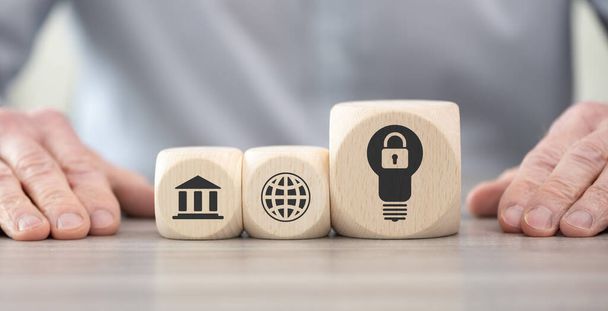 Wooden blocks with symbol of intellectual property concept - Photo, Image