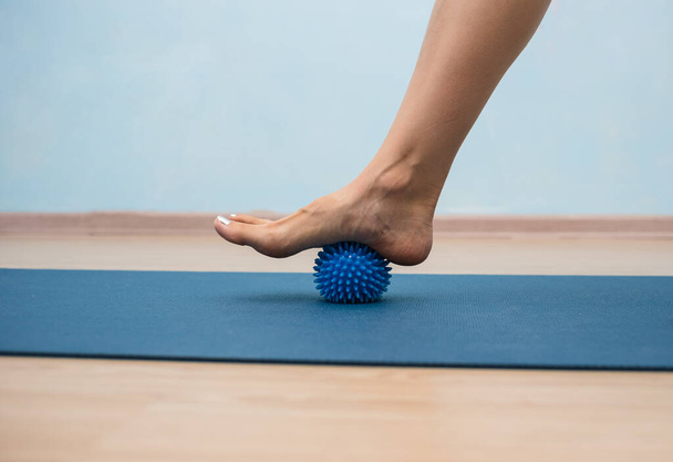 close-up of a person's leg doing exercises with a massage ball with needles - Photo, Image