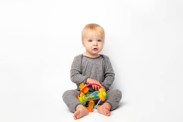 Kid playing with colorful educational toy boll. Little boy with Educational and creative toys. games for young children. Baby on white background. development of fine motor skills of children concept - Fotoğraf, Görsel