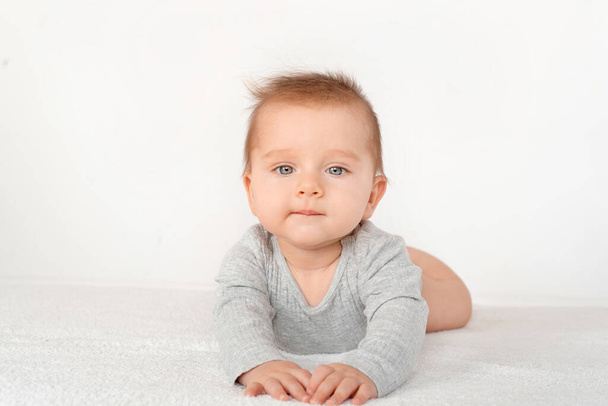 Portrait of a cute baby boy with blue eyes on white background. Healthy childhood innocence concept. - Fotoğraf, Görsel