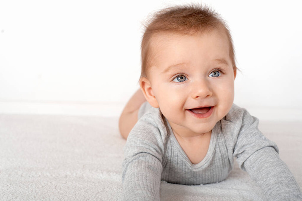 Portrait of a cute baby boy with blue eyes on white background. Healthy childhood innocence concept. - Foto, imagen