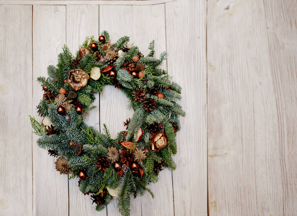 Christmas wreath decorated with nutshells, pine cones, beads - Photo, Image