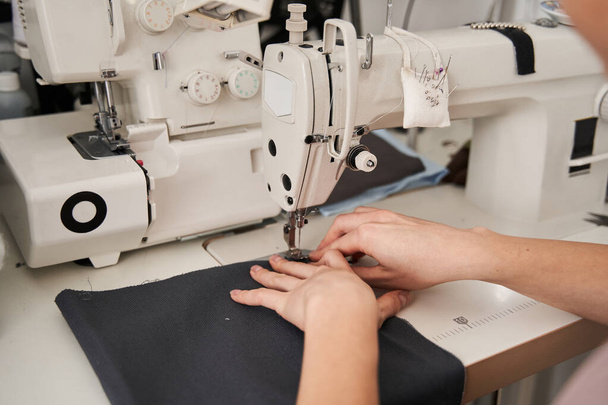 Seamstress using sewing machine - Foto, Imagen