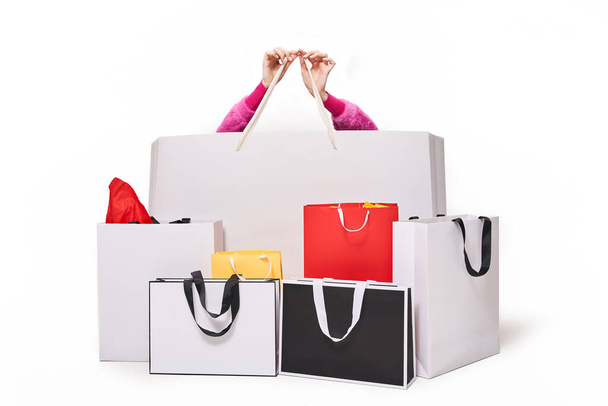 Woman sitting behind shopping bags after online shopping - Fotó, kép