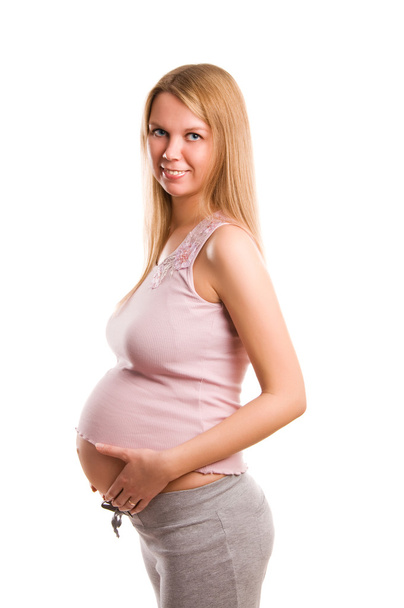 Beautiful young pregnant blond girl on white background - Photo, image