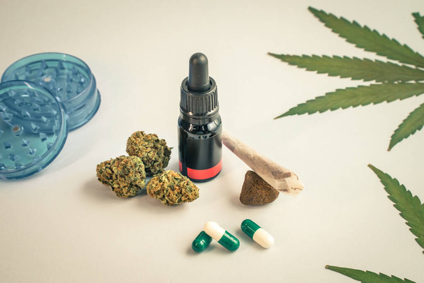 CBD oil, capsules and hemp buds on white background. Organic and natural hemp-based cosmetic and beauty products. Medical cannabis concept. Alternative medicine. Copy space for text. - 写真・画像