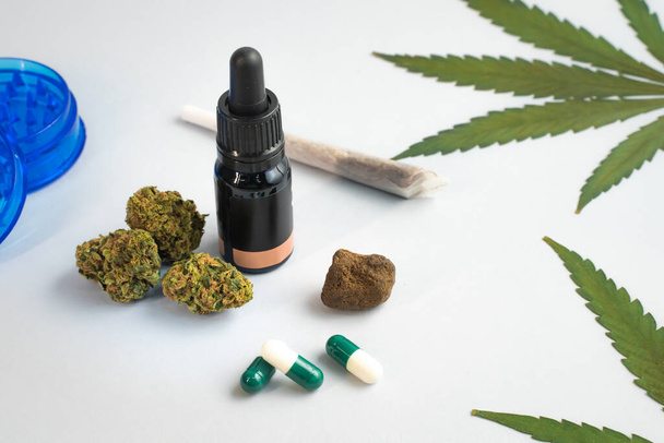 CBD oil, capsules and hemp buds on white background. Organic and natural hemp-based cosmetic and beauty products. Medical cannabis concept. Alternative medicine. Copy space for text. - Foto, Bild