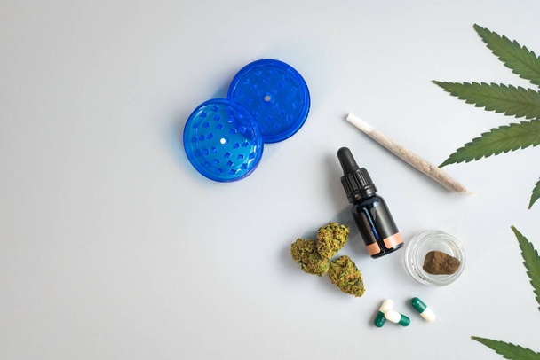 CBD oil, capsules and hemp buds on white background. Organic and natural hemp-based cosmetic and beauty products. Medical cannabis concept. Alternative medicine. Copy space for text. - 写真・画像