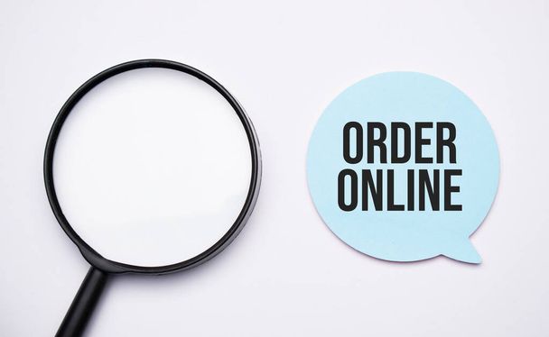 order online speech bubble and black magnifier isolated on the yellow background. - Фото, изображение