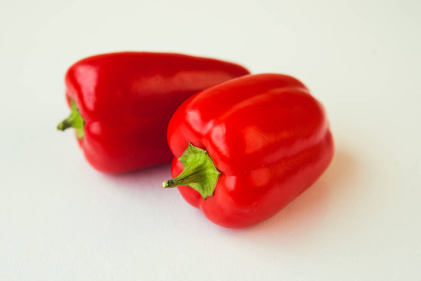 Two red sweet peppers on white background. - Photo, image