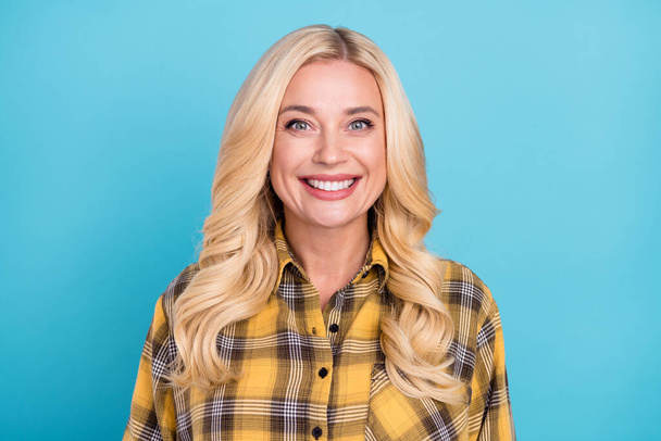 Portrait of attractive content cheerful wavy-haired woman wearing checked shirt isolated over vivid blue color background - Foto, Bild
