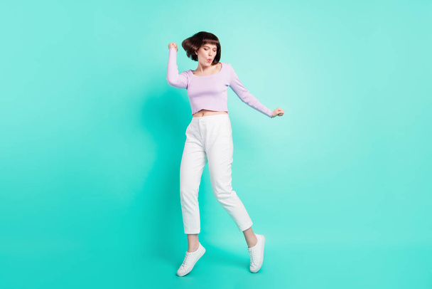 Full length photo of shiny sweet woman dressed violet sweater smiling dancing isolated turquoise color background - Fotografie, Obrázek