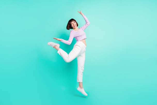 Full length body size photo woman funky jumping up gracefully cool isolated vibrant teal color background - Foto, afbeelding