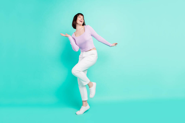 Full length body size photo woman happy overjoyed dancing at party looking copyspace isolated vivid teal color background - Foto, Imagen