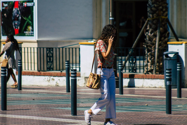Seville Spain September 04, 2021 Pedestrians walking in the street during the coronavirus outbreak hitting Spain, wearing a mask is not mandatory but most of people wear it - Φωτογραφία, εικόνα