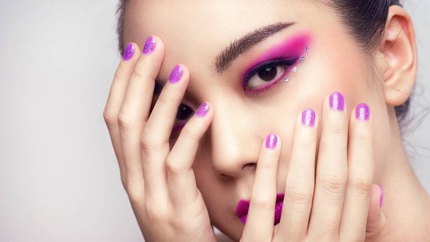 Asian female closeup colorful eyeshadow with extreme long false eyelashes. Eyelash Extensions. Makeup, Cosmetics, Beautiful cosmetics makeup concept. - Foto, Imagem